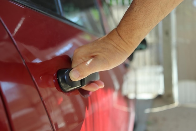 A man opens the back door of his car