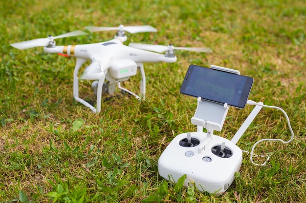 Man Operating Drone Flying or Hovering by Remote Control in Nature