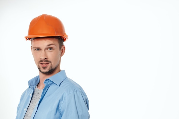 Man in orange helmet protection isolated background High quality photo