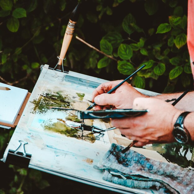 Man painting outdoors