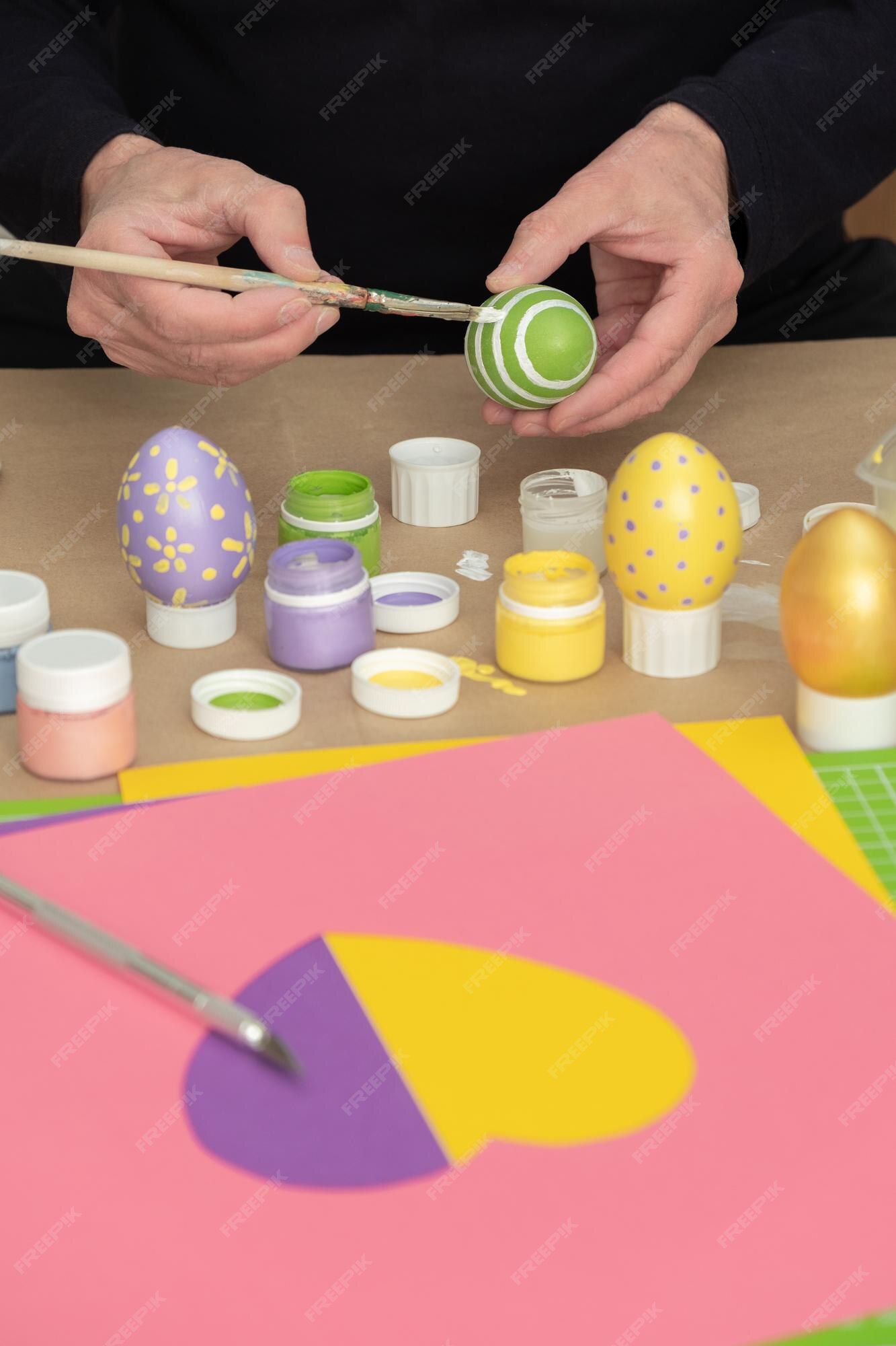 Premium Photo | Man paints the easter eggs while enjoying diy ...