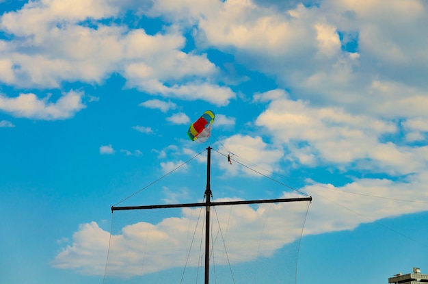A man on a parachute over the sea.