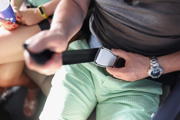 Man passenger fasten seat belt while sitting on airplane during vacation trip