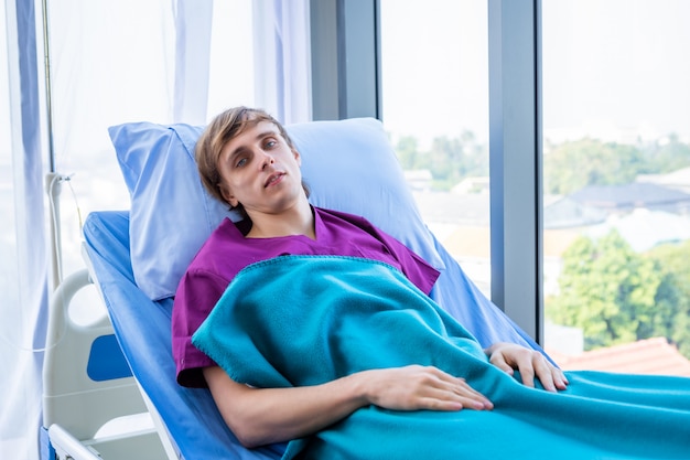 man patient sitting in his bed