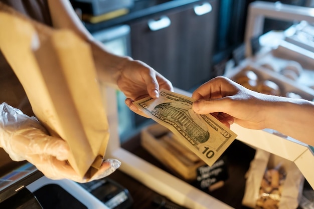 Man paying for a pie in coffee shop with usa dollars