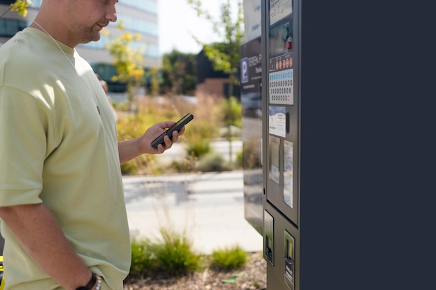 man pays his transport ticket with his mobile phone on platform station nfc contactless high quality