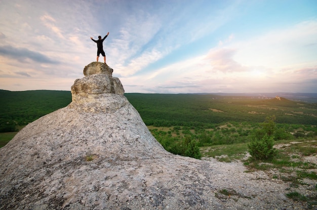 Man on peak of mountain. Emotional scene.