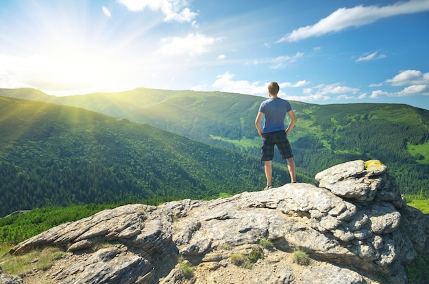 Man on peak of mountain