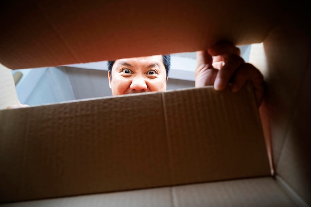 The man peeked into the box excitedly