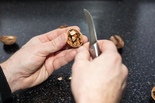 A man peeled a walnut with delicious fresh fruit