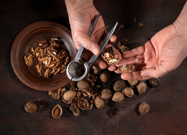 Man peeling nuts with a nutcracker