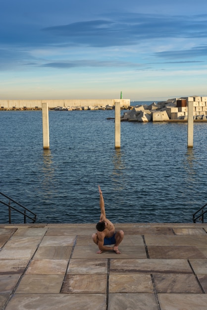 Man performing advanced yoga exercises and stretching.