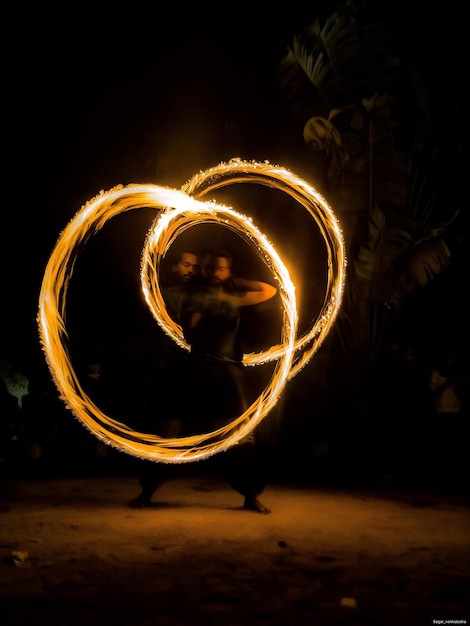 Photo man performing stunt by light painting at night