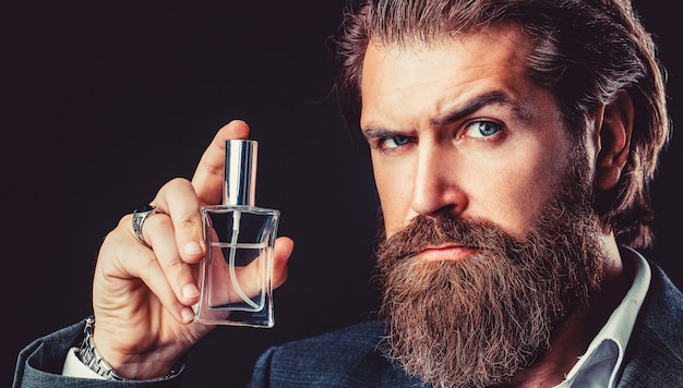 Man perfume, fragrance. Perfume or cologne bottle, perfumery, cosmetics, scent cologne bottle, male holding cologne.