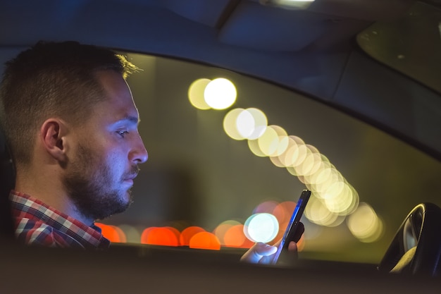 The man phone inside the car on the highway. evening night time