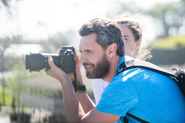 Man photographer with a large professional camera portrait of photographer with camera outdoor