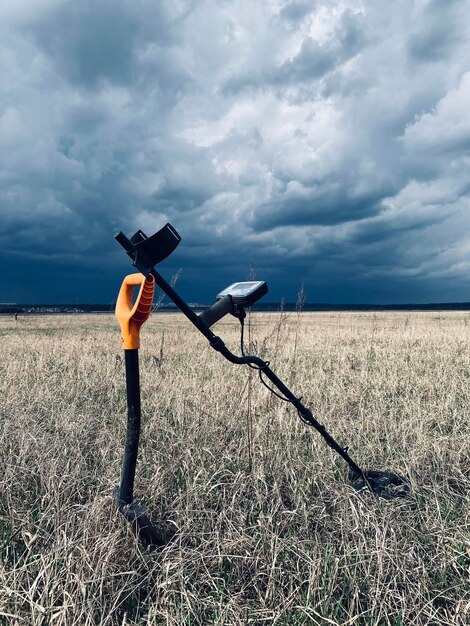 Man photographing on field against sky