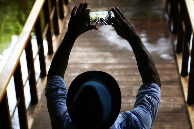 Man photographing his friends with a smart phone