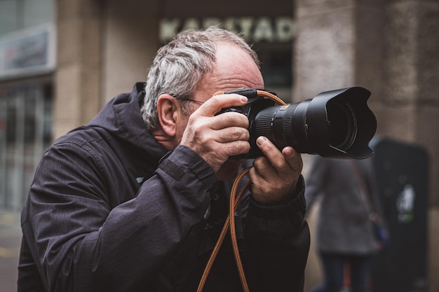 Photo man photographing while standing in city