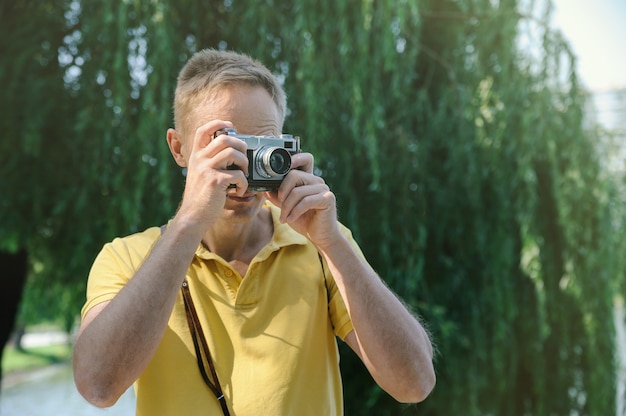 Man photographing with an old camera