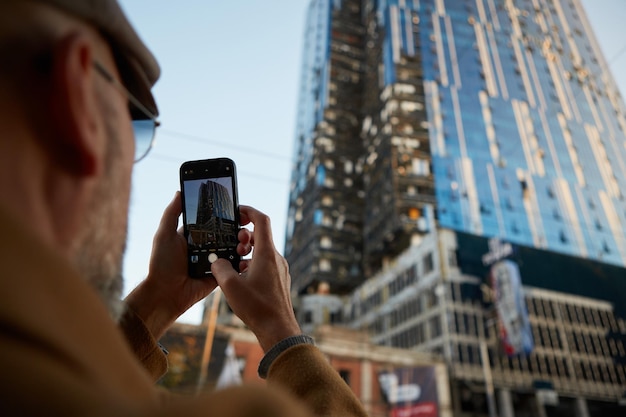 The man photographs business center building was hit by Russian shelling in Kyiv Ukraine