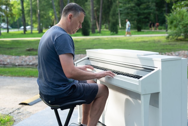 Man, piano player in outdoor, park