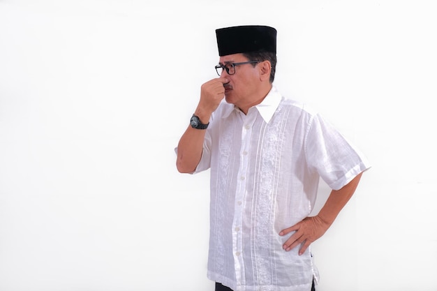 A man pinches his nose and one hand on his hips