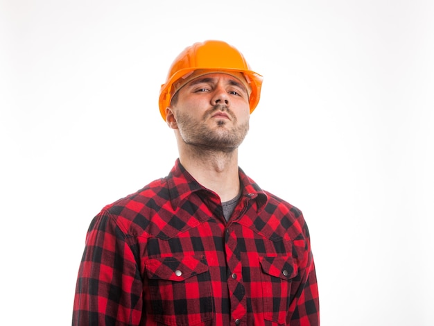 A man in a plaid shirt and a construction helmet isolated