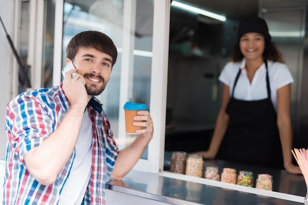 The man in the plaid shirt went to the food truck.