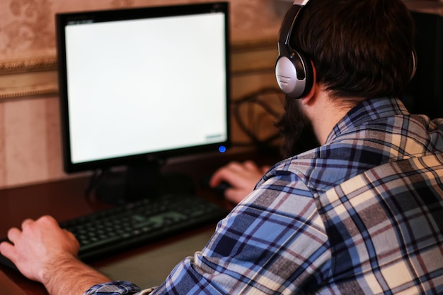 Man play computer with headphones