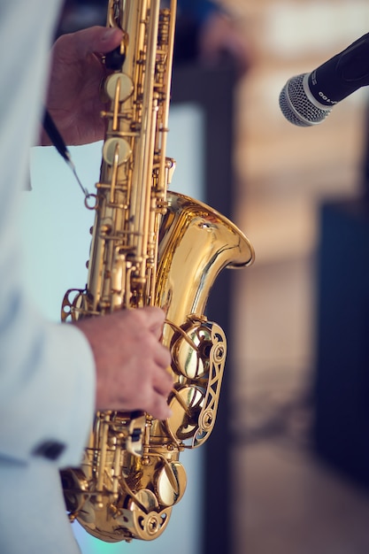 A man play with saxophone