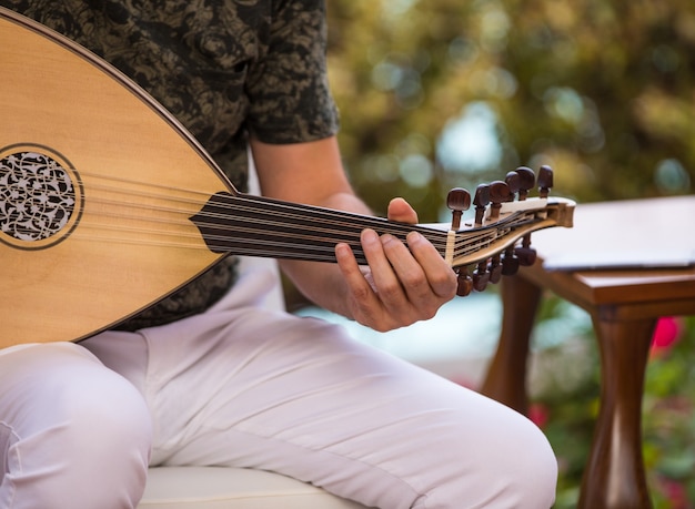 a man playing an arabic musical instrument