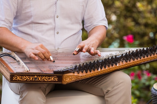 a man playing an arabic musical instrument