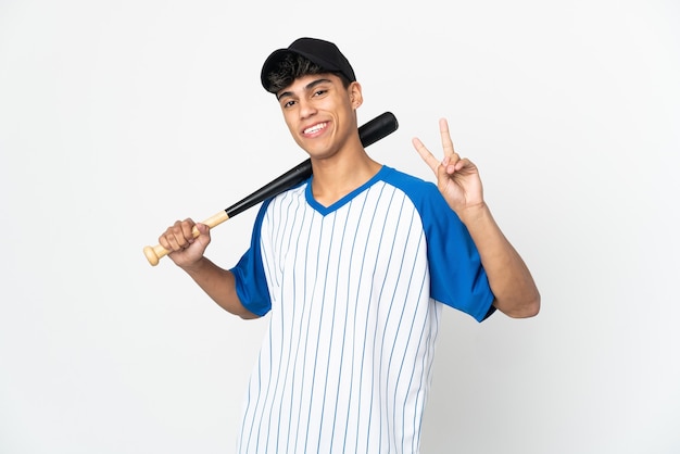 Man playing baseball on isolated white smiling and showing victory sign