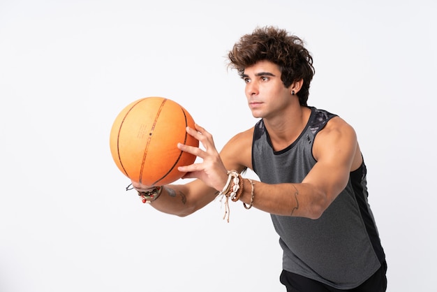 Man playing basketball over isolated wall