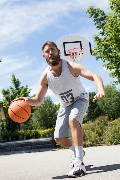 Man playing basketball on outdoor court