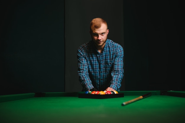 Man playing billiards in a club