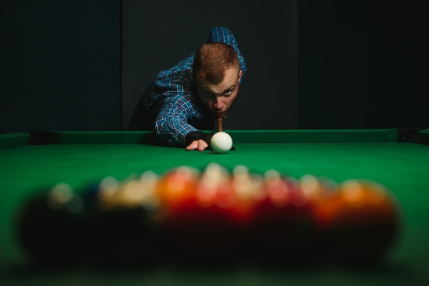 Man playing billiards in a club