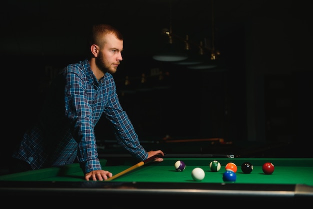 Man playing billiards in a club