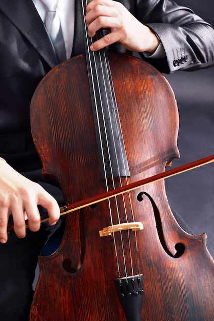 Man playing on cello close up