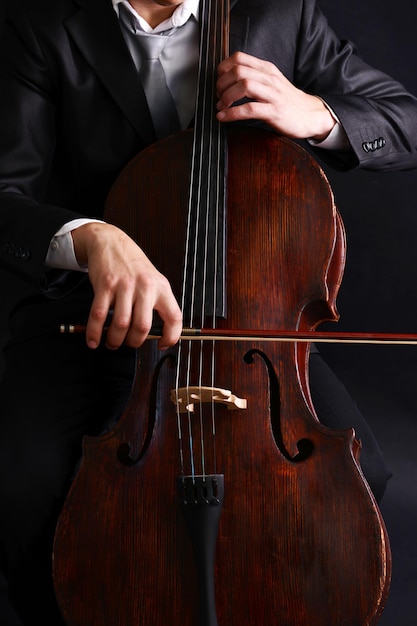 Man playing on cello close up