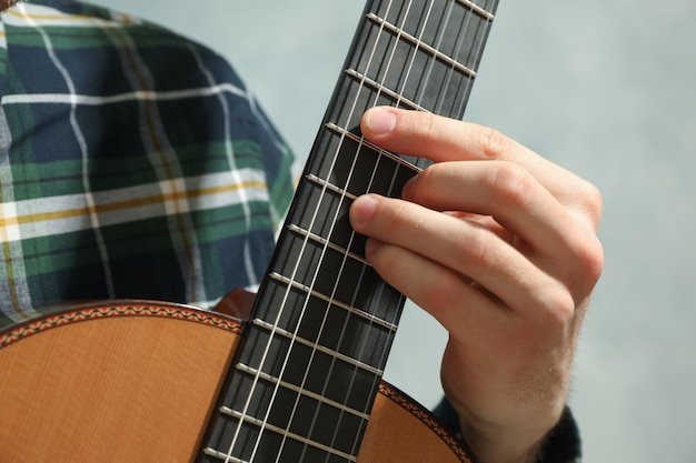 Man playing on classic guitar, closeup