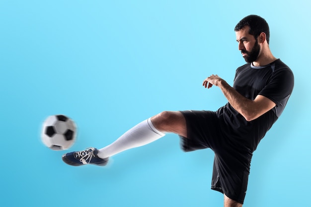 Man playing football on colorful background