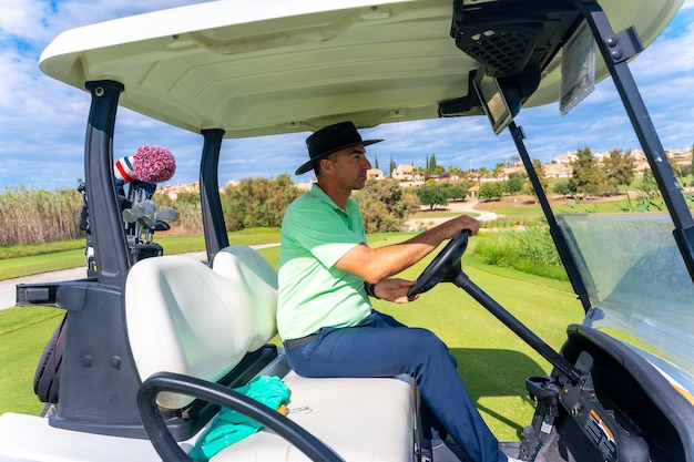 Man playing golf in the buggy car after the launch of the ball next to a lake