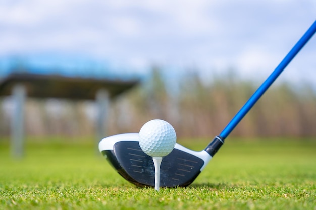 Man playing golf at golf club by a lake preparing to hit