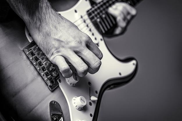 Man playing guitar Close up hand playing guitar Musician playing guitar live music Musical instrument Black and white