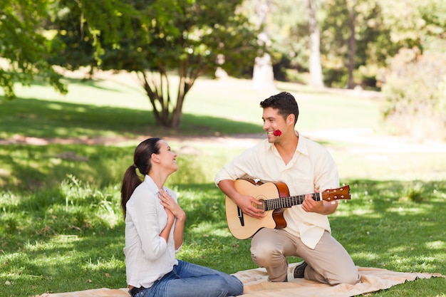 Man playing guitar for his girlfriend