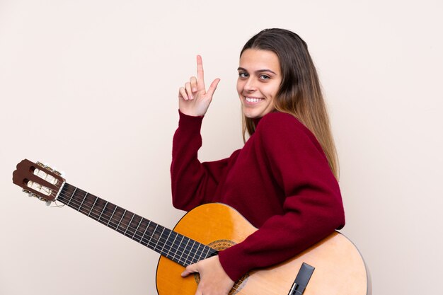 man playing the guitar over isolated wall