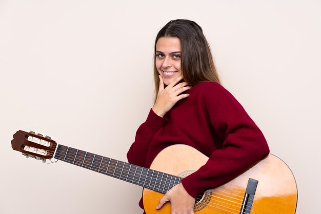 man playing the guitar over isolated wall