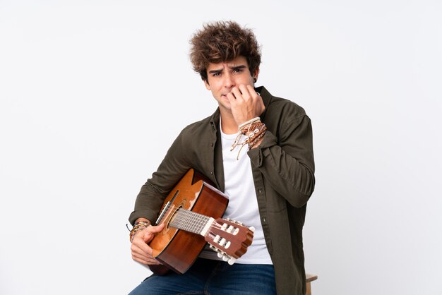 Man playing guitar over isolated wall